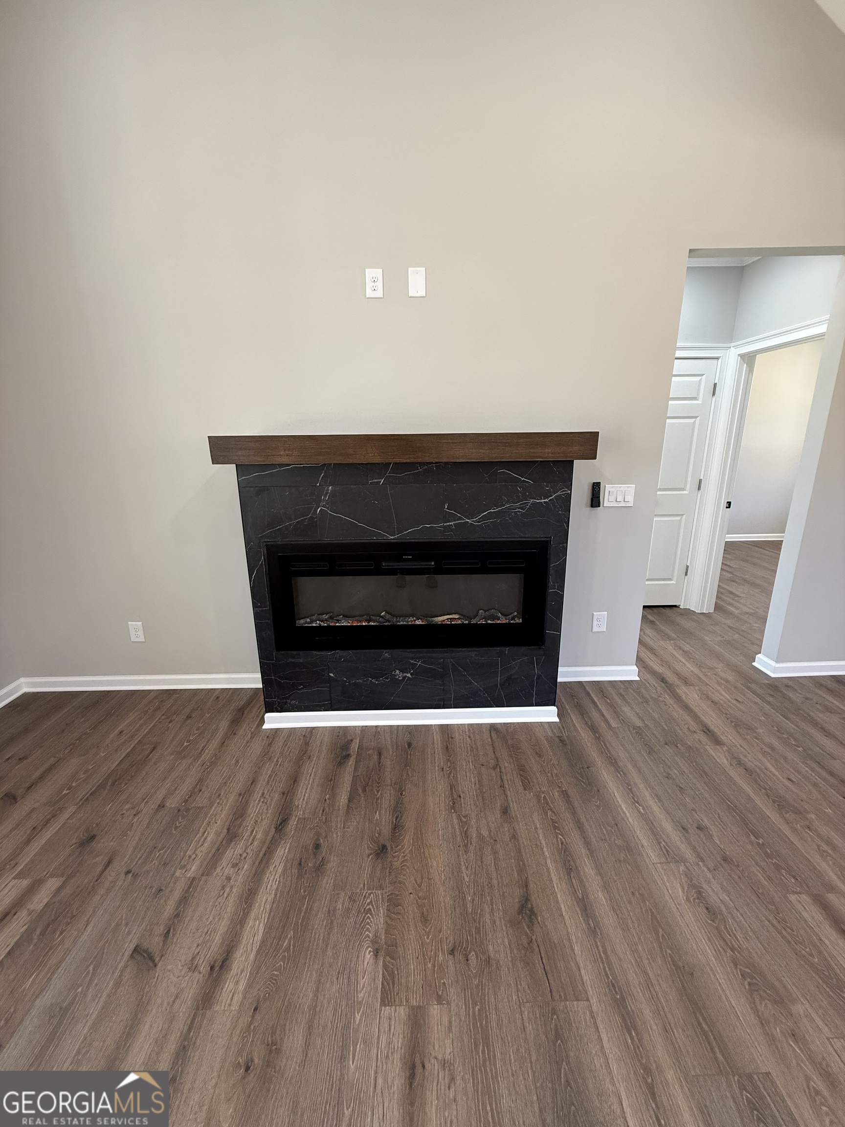 1205 Rocky Creek Road Hampton, GA 30228 - Photo 18 of 55 a room with wooden floors and a fireplace