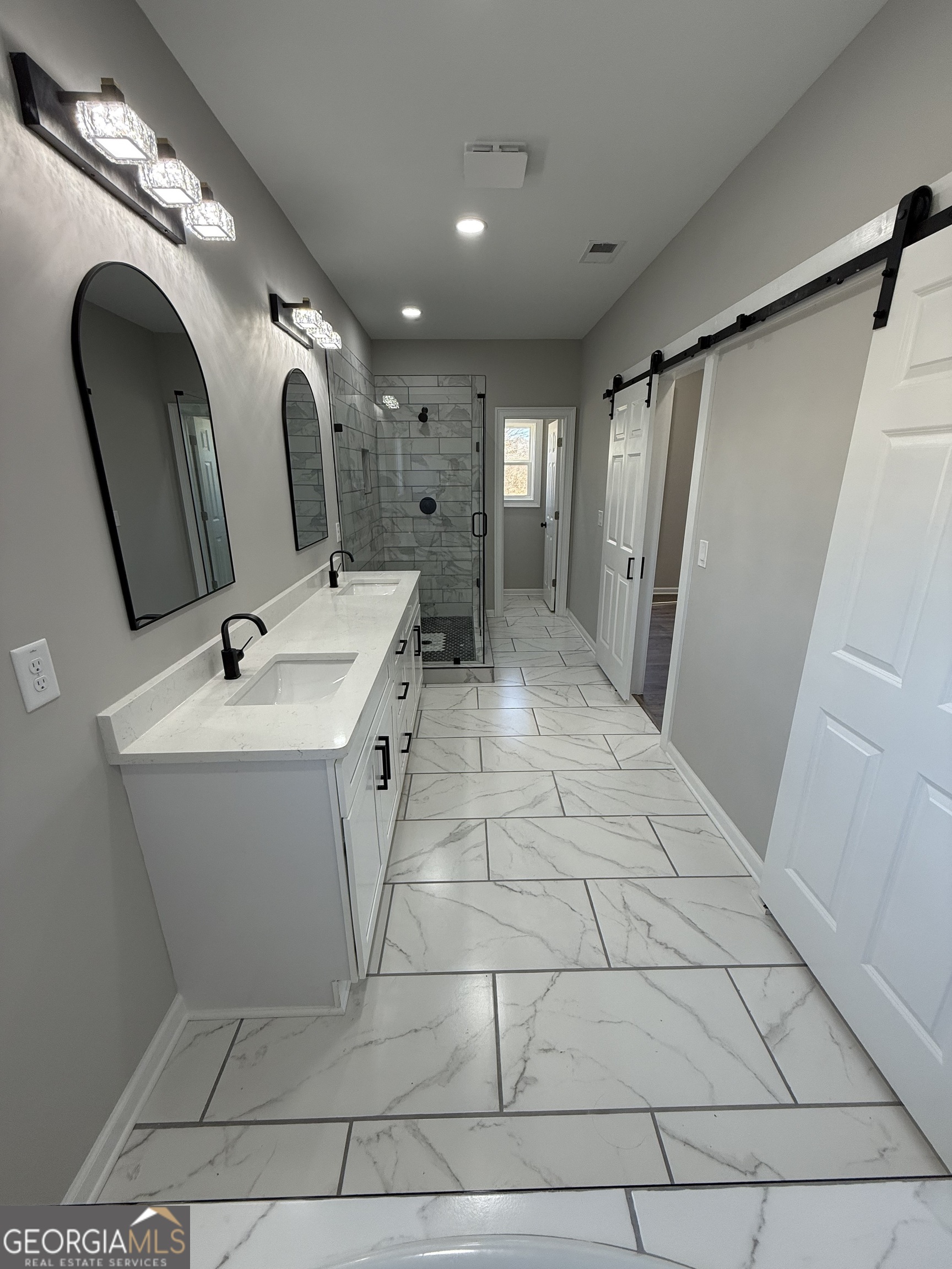 1205 Rocky Creek Road Hampton, GA 30228 - Photo 25 of 55 a bathroom with a sink a mirror and a shower