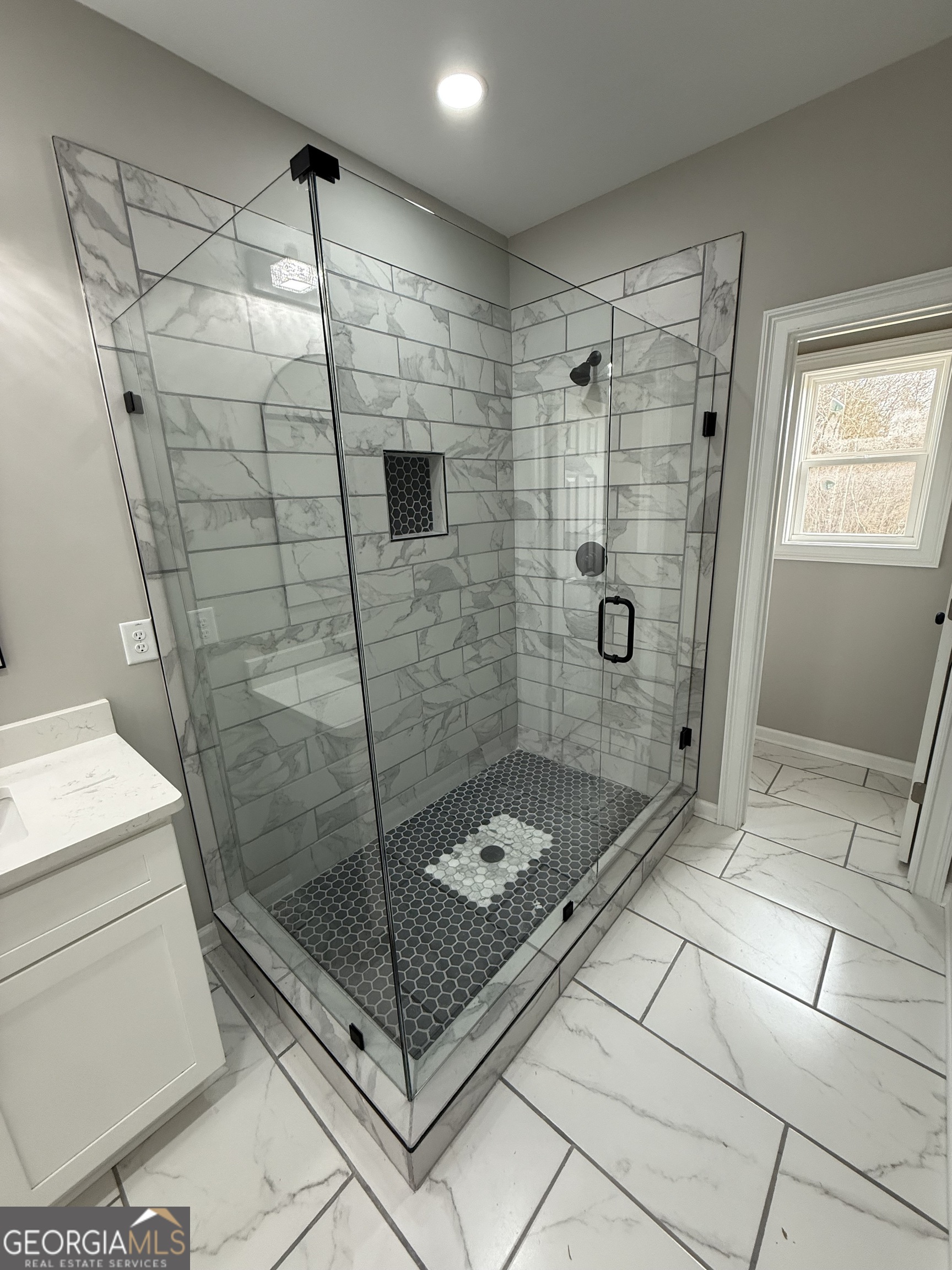 1205 Rocky Creek Road Hampton, GA 30228 - Photo 26 of 55 a bathroom with a glass shower door