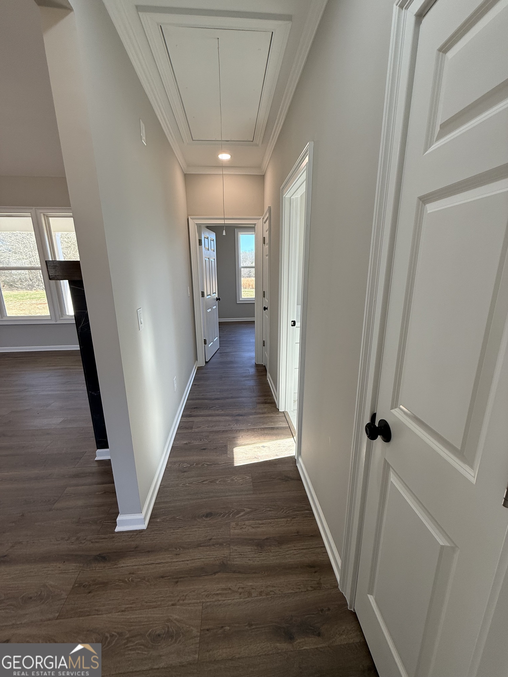 1205 Rocky Creek Road Hampton, GA 30228 - Photo 29 of 55 a view of a hallway with wooden floor and staircase