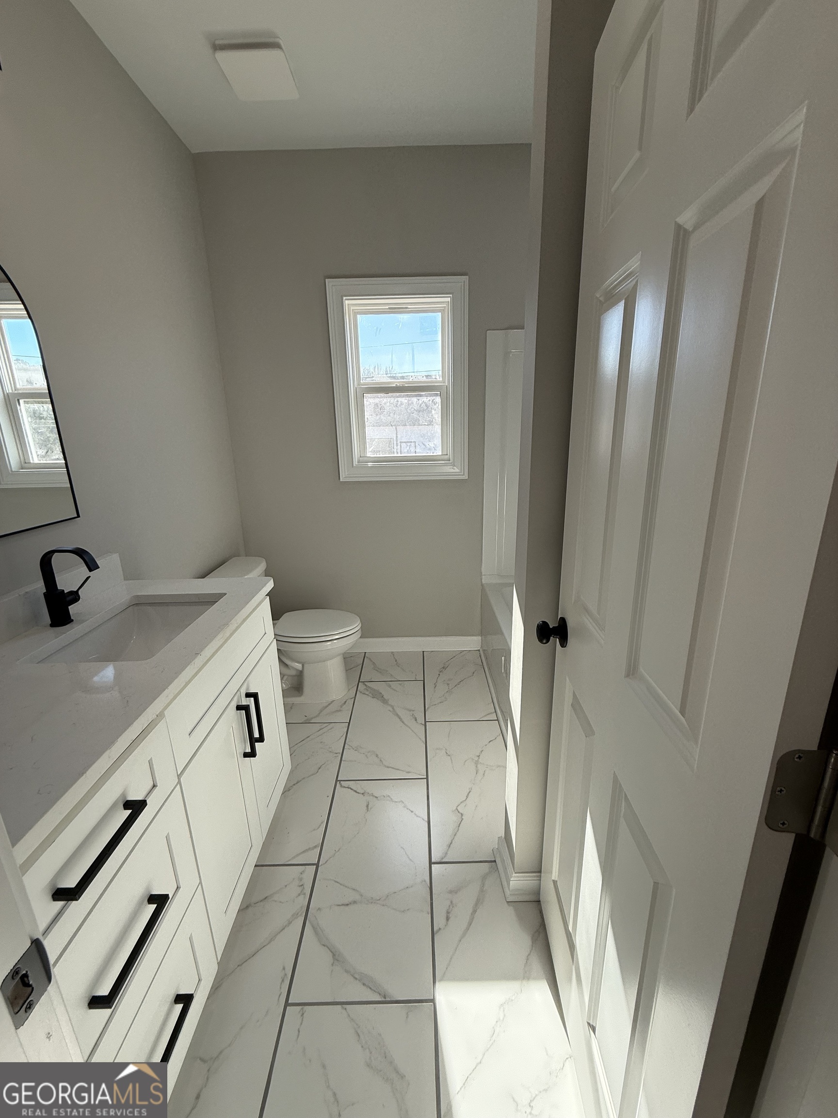 1205 Rocky Creek Road Hampton, GA 30228 - Photo 33 of 55 a bathroom with a sink a toilet and a mirror