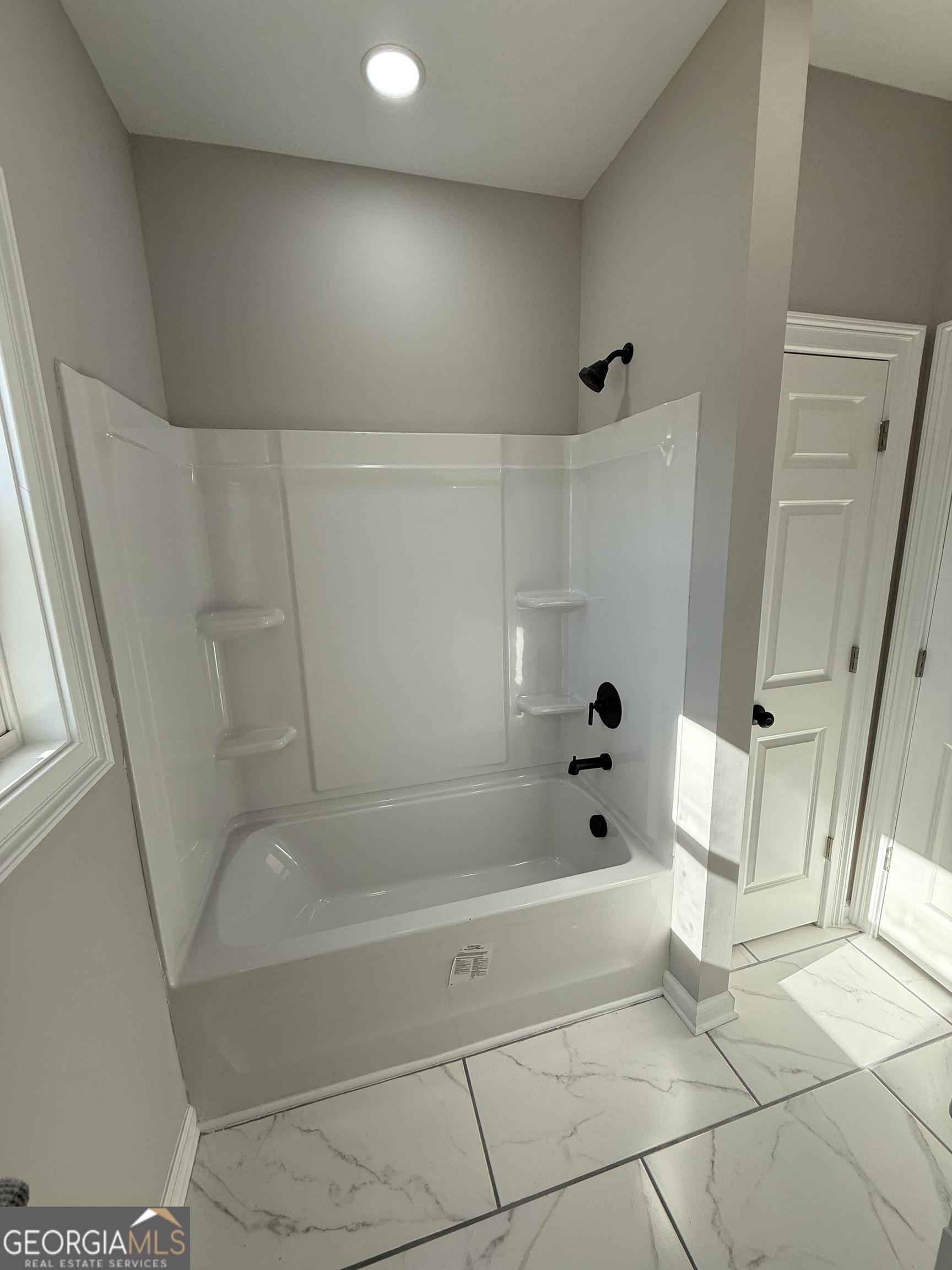 1205 Rocky Creek Road Hampton, GA 30228 - Photo 35 of 55 a bathroom with a bathtub and shower