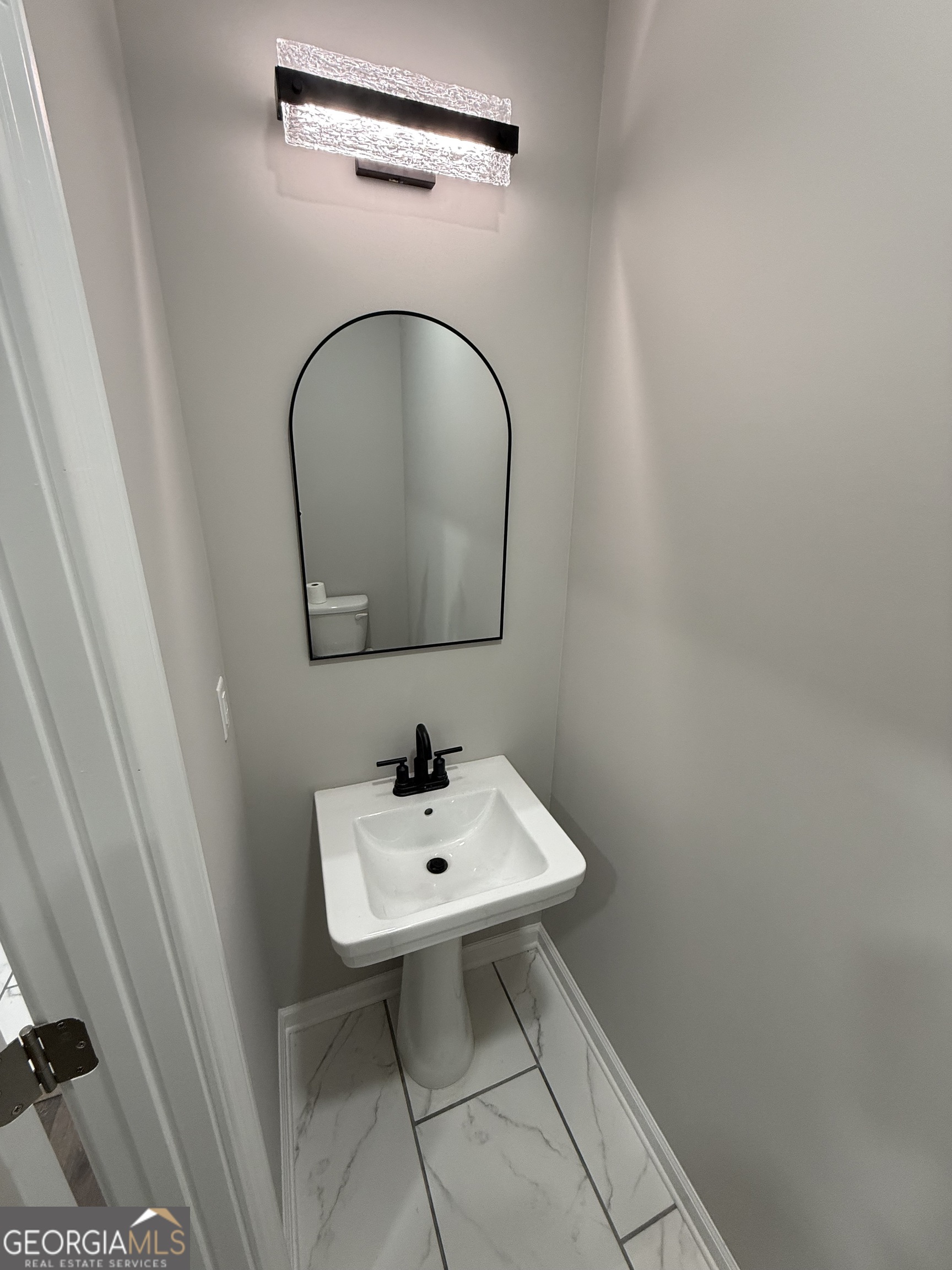 1205 Rocky Creek Road Hampton, GA 30228 - Photo 40 of 55 a bathroom with a sink and a mirror