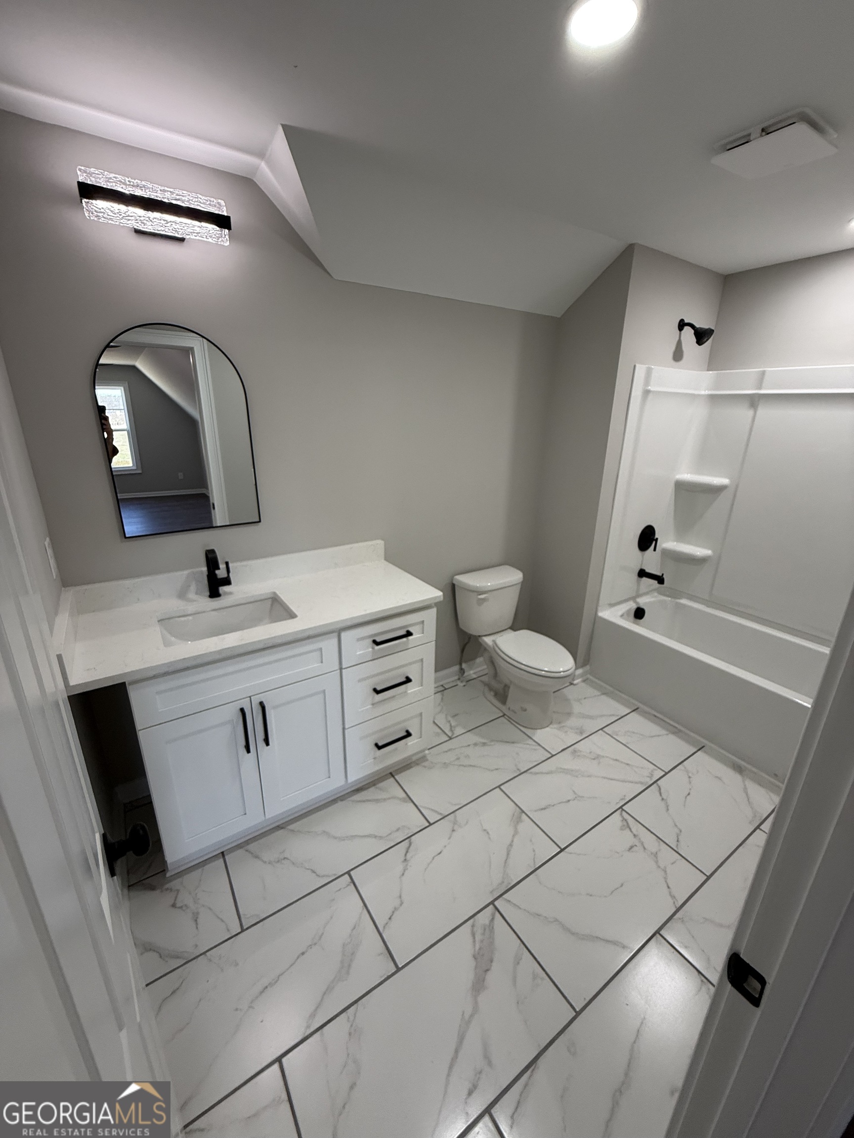 1205 Rocky Creek Road Hampton, GA 30228 - Photo 50 of 55 a bathroom with a sink mirror and toilet