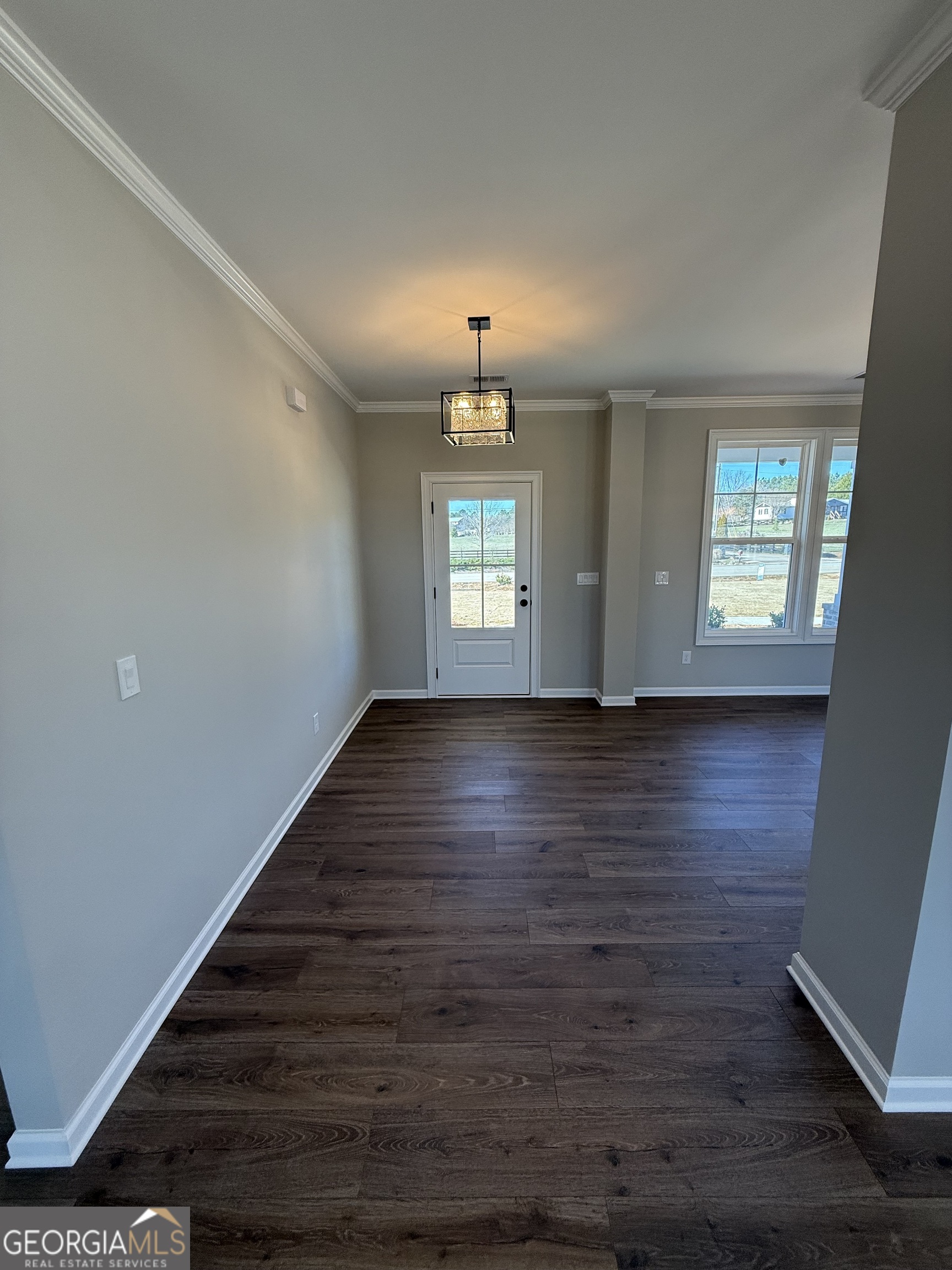 1205 Rocky Creek Road Hampton, GA 30228 - Photo 7 of 55 a view of an empty room with wooden floor and a window