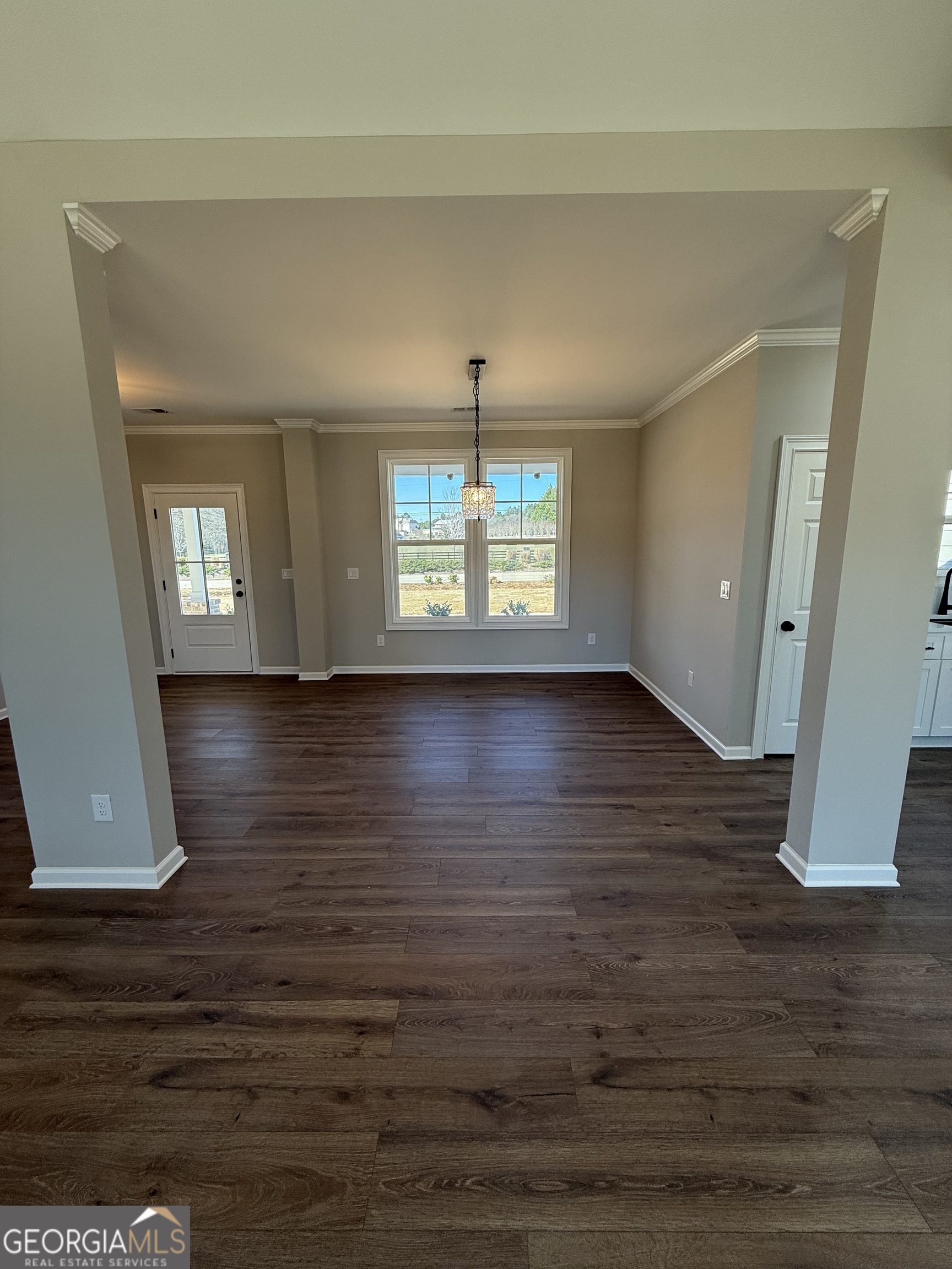 1205 Rocky Creek Road Hampton, GA 30228 - Photo 9 of 55 an empty room with wooden floor and windows