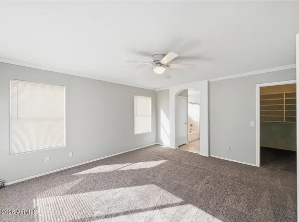 a view of a livingroom with a ceiling fan and window