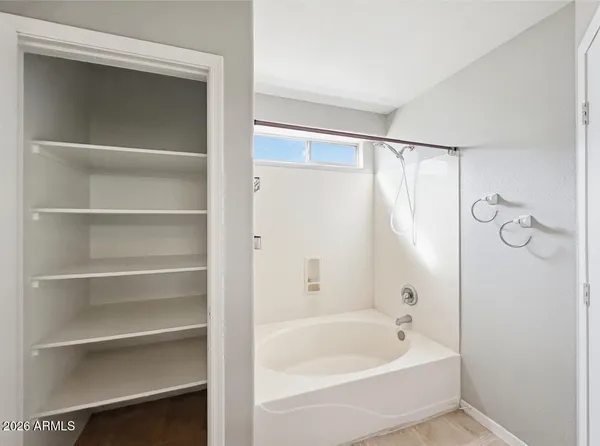 a white bath tub with a shower