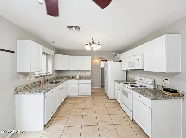 a large kitchen with a stove a sink dishwasher and a refrigerator