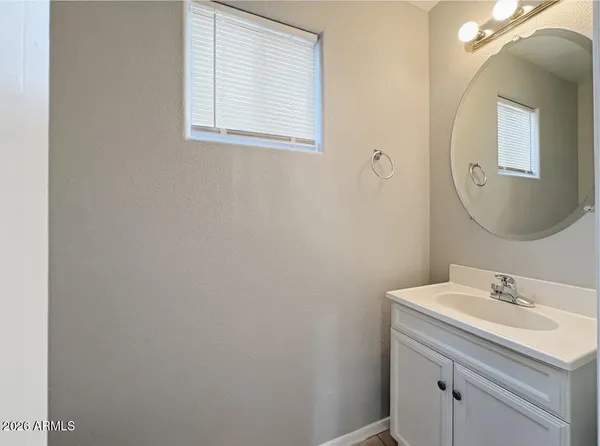 a bathroom with a sink vanity and a mirror
