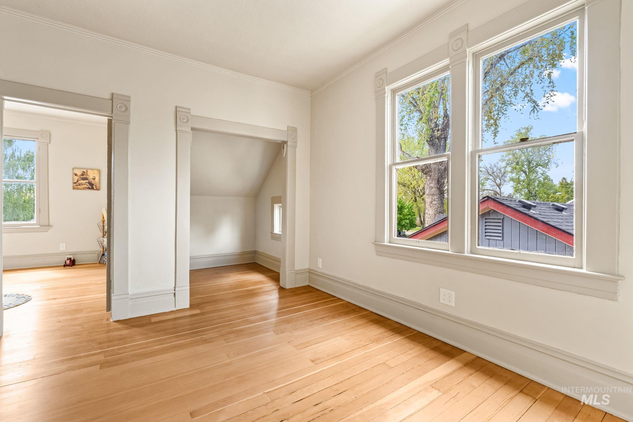 424 West Main Street Weiser, ID 83672 - Photo 18 of 30 Light wood-finish flooring complements the white walls and gray trim