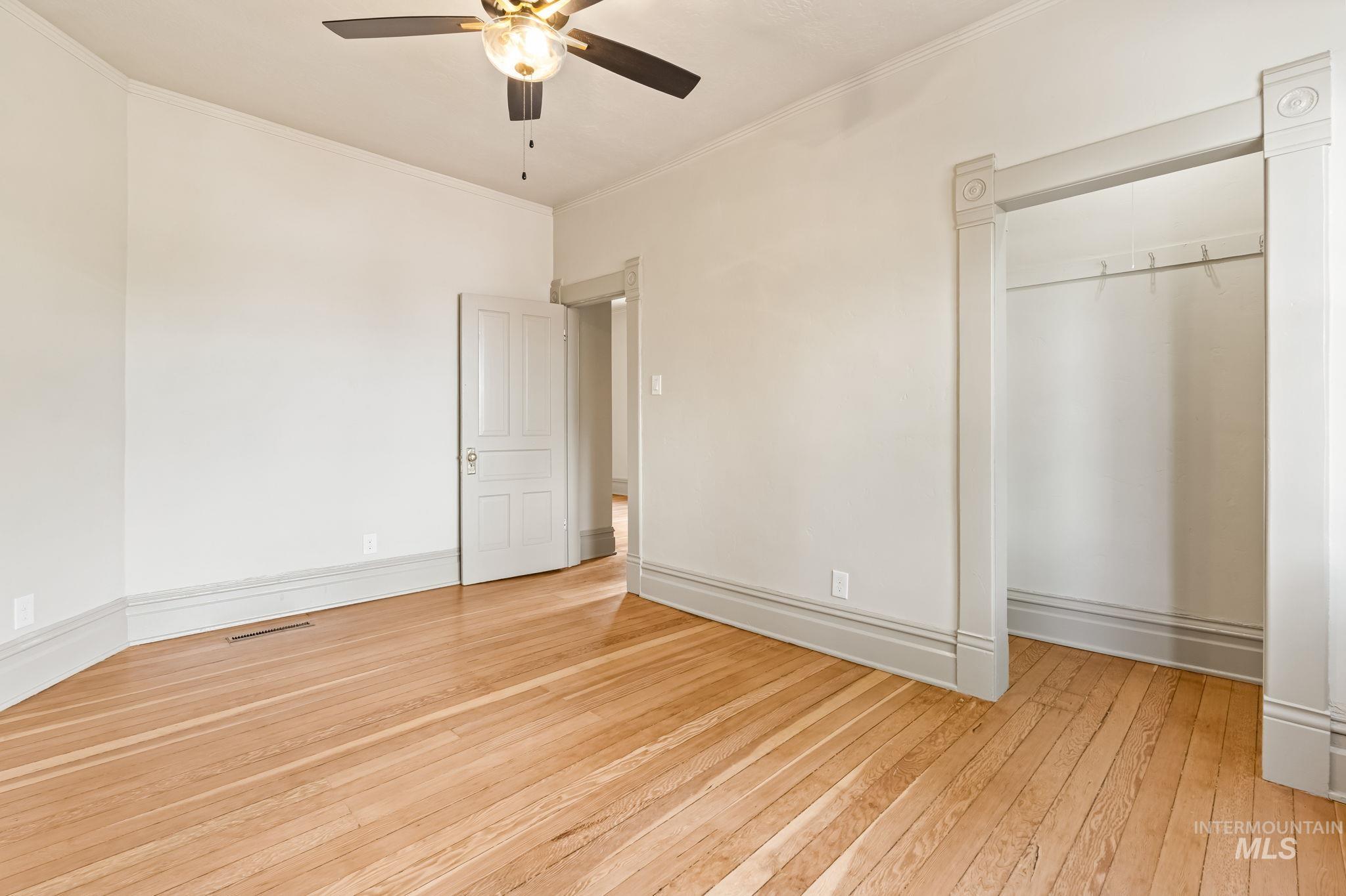 424 West Main Street Weiser, ID 83672 - Photo 23 of 30 Hardwood flooring extending throughout, complemented by a ceiling fan with integrated lighting