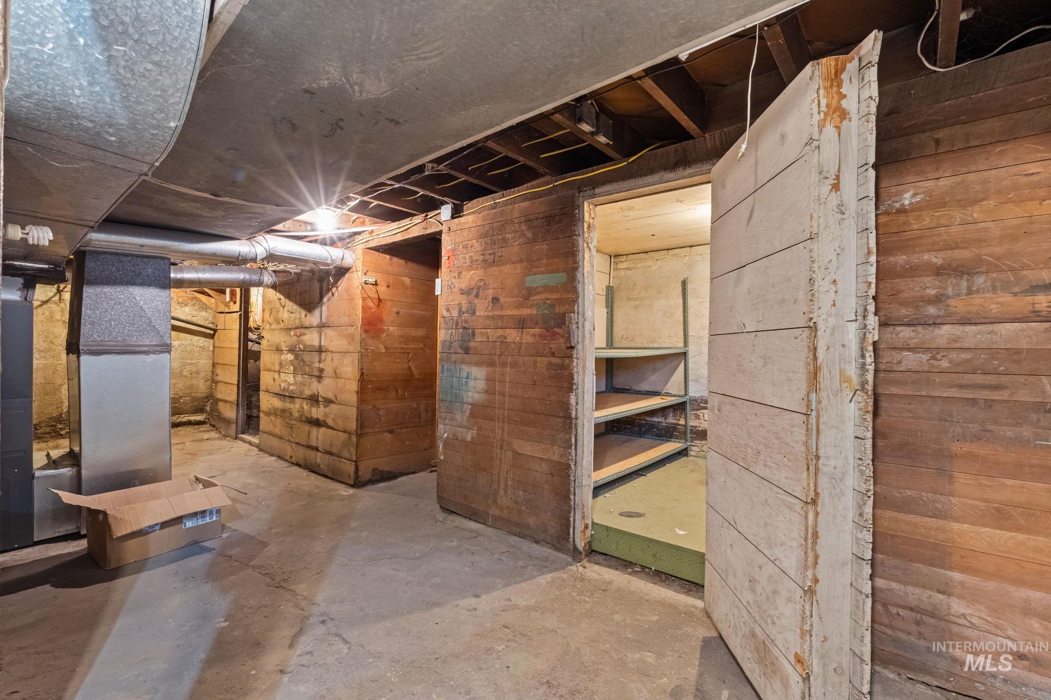 424 West Main Street Weiser, ID 83672 - Photo 25 of 30 Unfinished basement with concrete flooring and exposed wooden plank walls