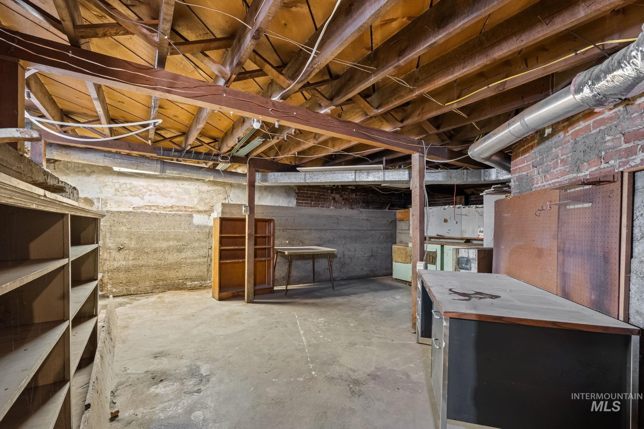 424 West Main Street Weiser, ID 83672 - Photo 26 of 30 Unfinished basement with exposed ceiling joists and concrete flooring