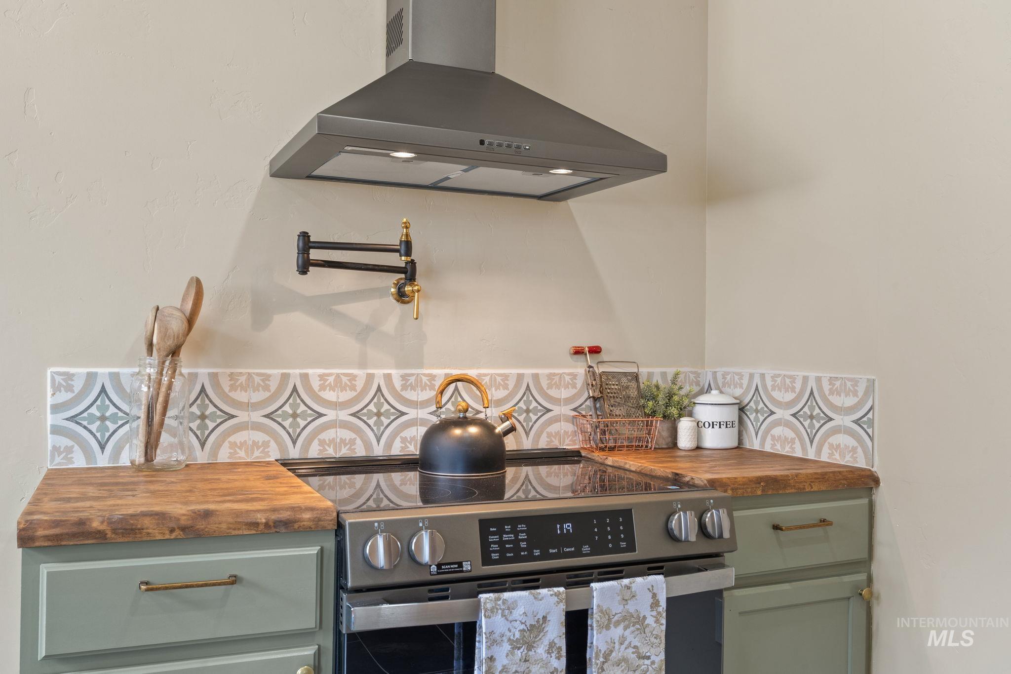 424 West Main Street Weiser, ID 83672 - Photo 8 of 30 Stainless steel electric range with a coordinating range hood