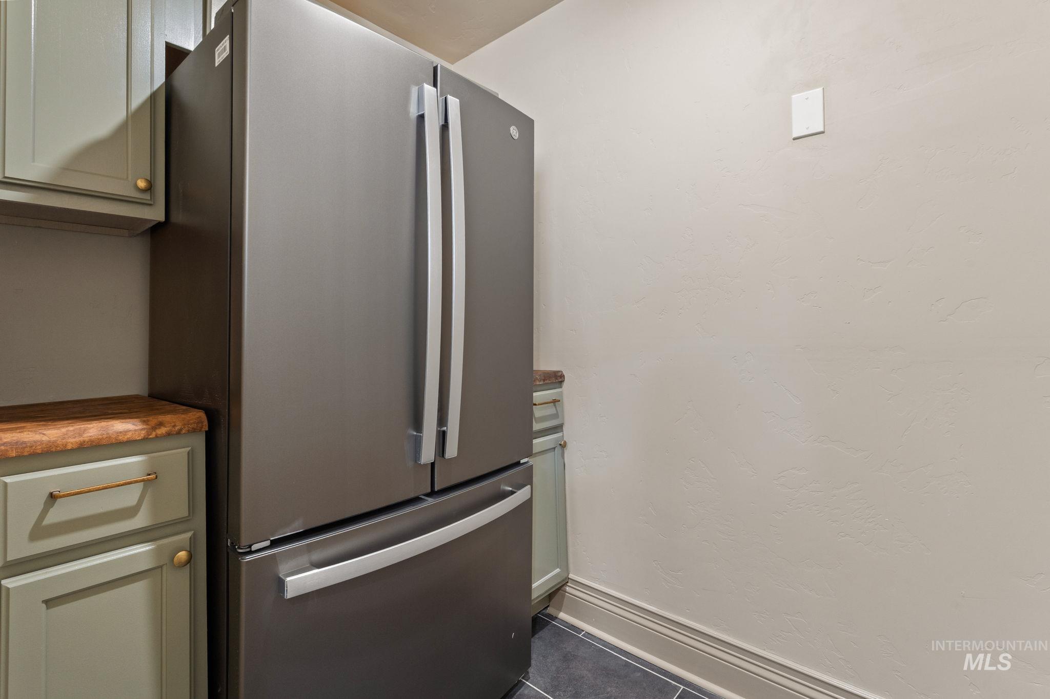 424 West Main Street Weiser, ID 83672 - Photo 10 of 30 Stainless steel French door refrigerator set against a textured wall