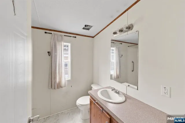 a bathroom with a shower and a window