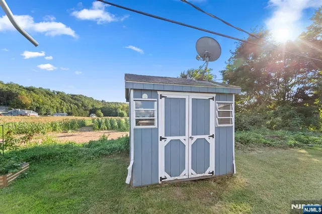 a view of a backyard with plants and outdoor seating