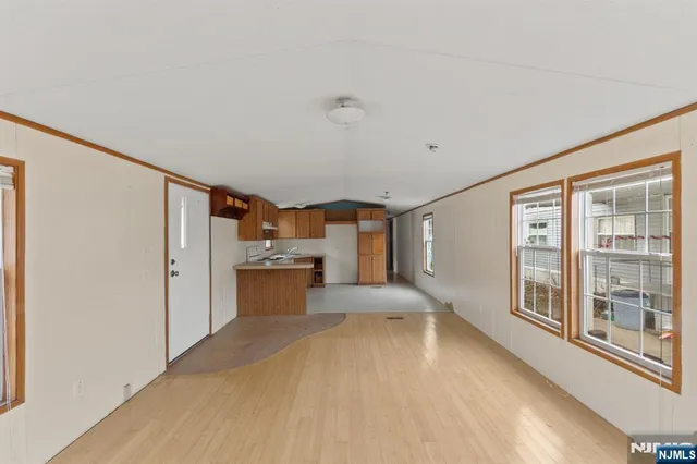 a view of a kitchen with a sink and a large window