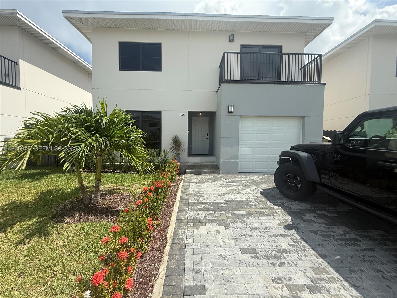 a row of potted plants in front of a house