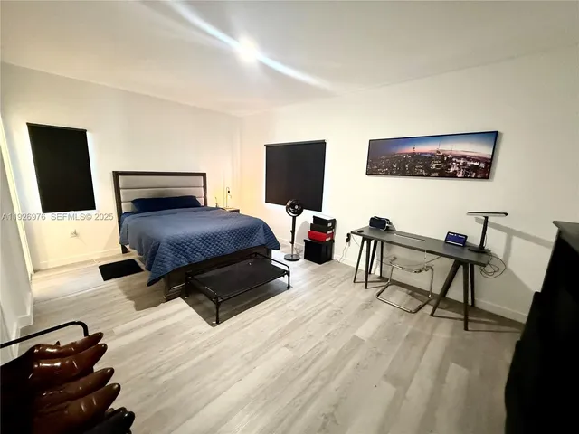a bathroom with a double vanity sink mirror and bathtub