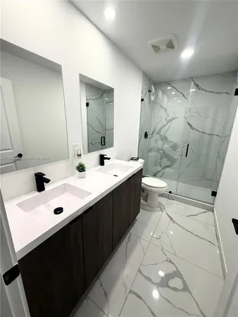 a kitchen with refrigerator and cabinets