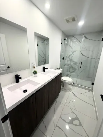 a kitchen with refrigerator and cabinets