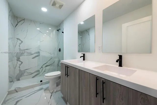 a bathroom with a sink toilet and shower