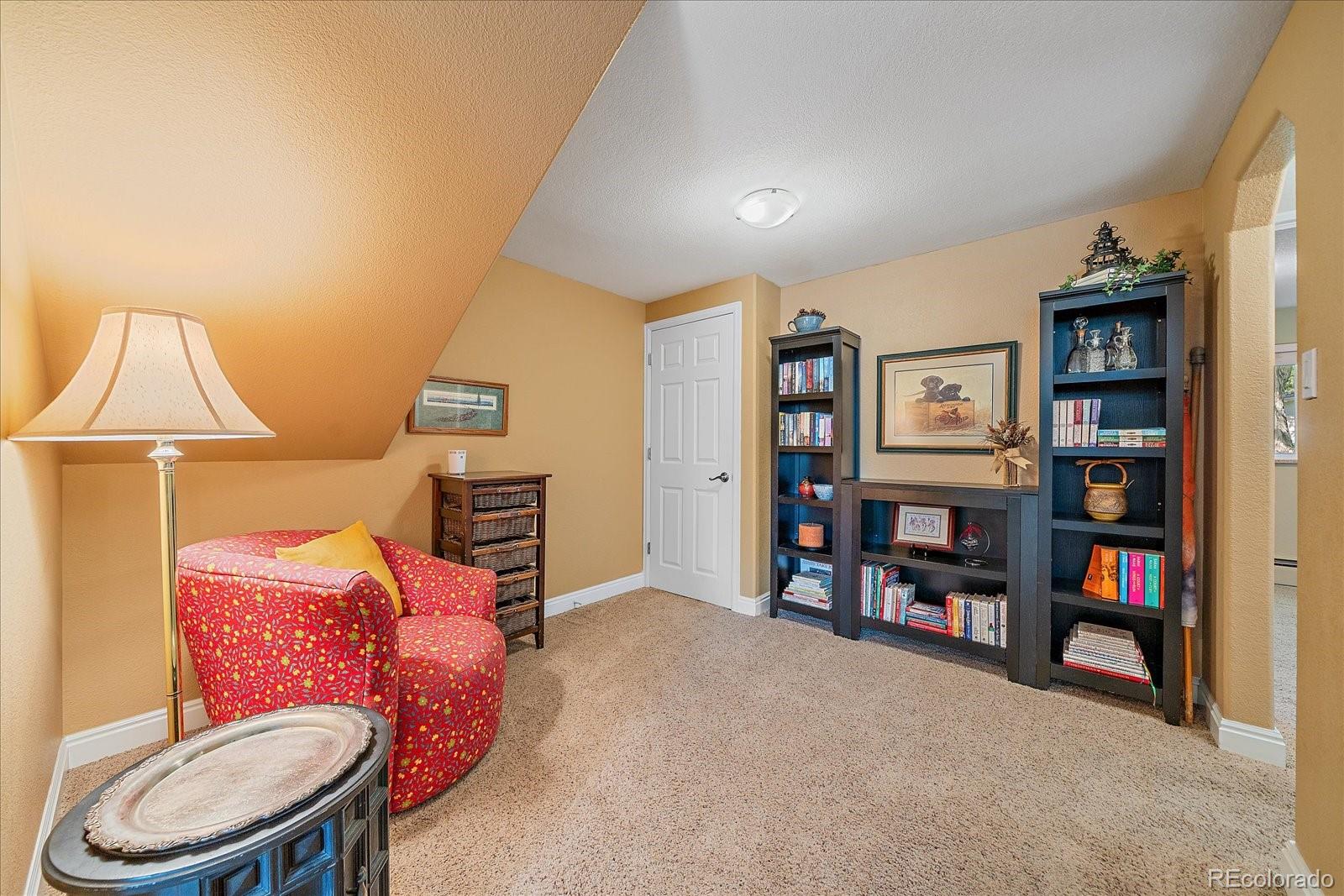 930 Reed Court Lakewood, CO 80214 - Photo 22 of 41 a living room with furniture and a book shelf