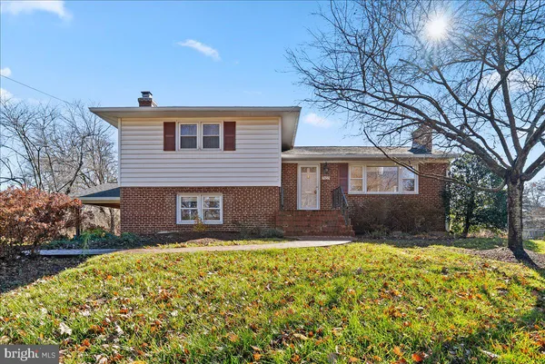 a front view of a house with a yard and outdoor seating