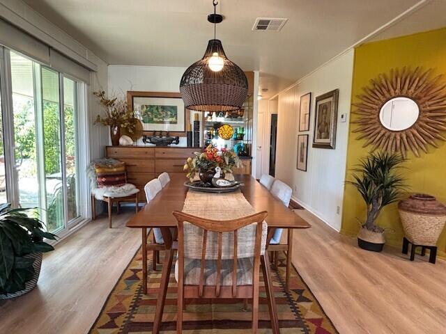 49305 Highway 74, Unit 109 Palm Desert, CA 92260 - Photo 12 of 52 a dining room filled chandelier and wooden floor