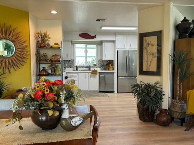 49305 Highway 74, Unit 109 Palm Desert, CA 92260 - Photo 13 of 52 a kitchen with a refrigerator and potted plant