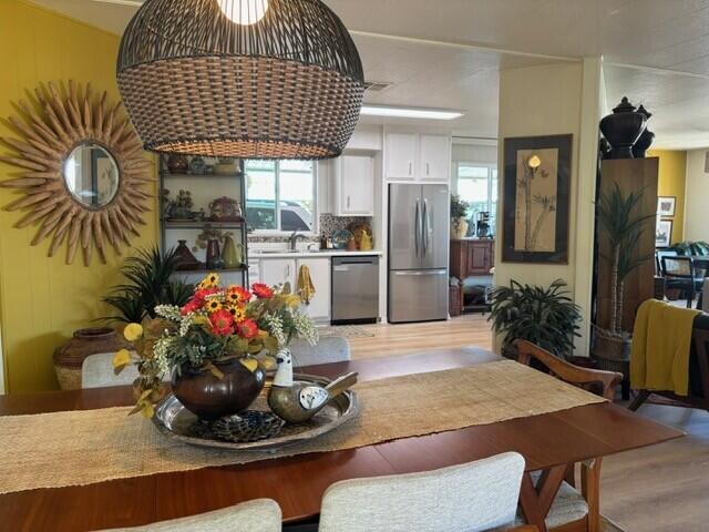 49305 Highway 74, Unit 109 Palm Desert, CA 92260 - Photo 14 of 52 a room with furniture a chandelier and a wooden floor