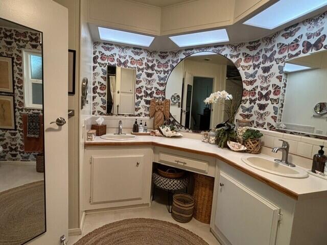 49305 Highway 74, Unit 109 Palm Desert, CA 92260 - Photo 24 of 52 a bathroom with a sink and a mirror