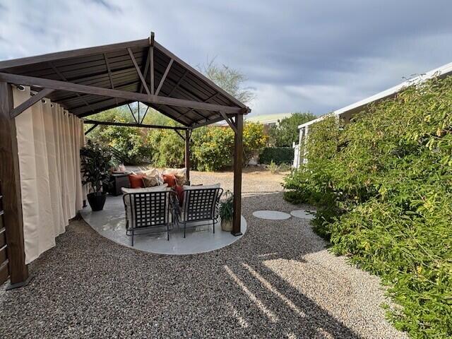 49305 Highway 74, Unit 109 Palm Desert, CA 92260 - Photo 31 of 52 a patio with glass top table and chairs