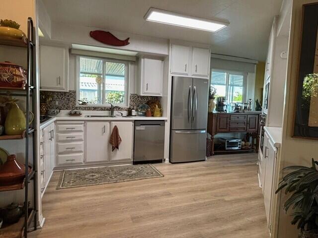 49305 Highway 74, Unit 109 Palm Desert, CA 92260 - Photo 5 of 52 a kitchen with a refrigerator and a stove