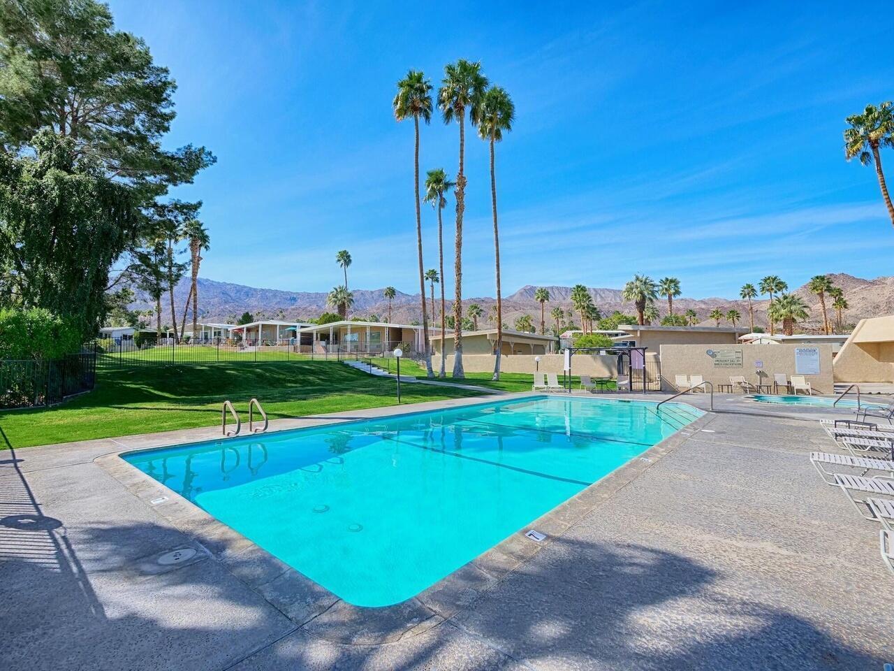 49305 Highway 74, Unit 109 Palm Desert, CA 92260 - Photo 51 of 52 a view of a swimming pool and lounge chairs