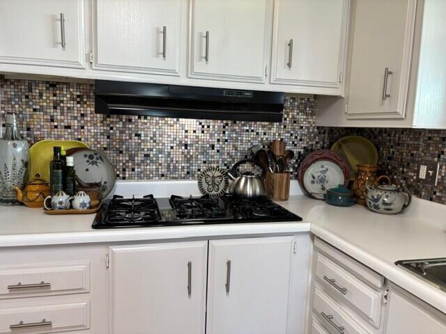 49305 Highway 74, Unit 109 Palm Desert, CA 92260 - Photo 9 of 52 a kitchen with a stove and cabinets