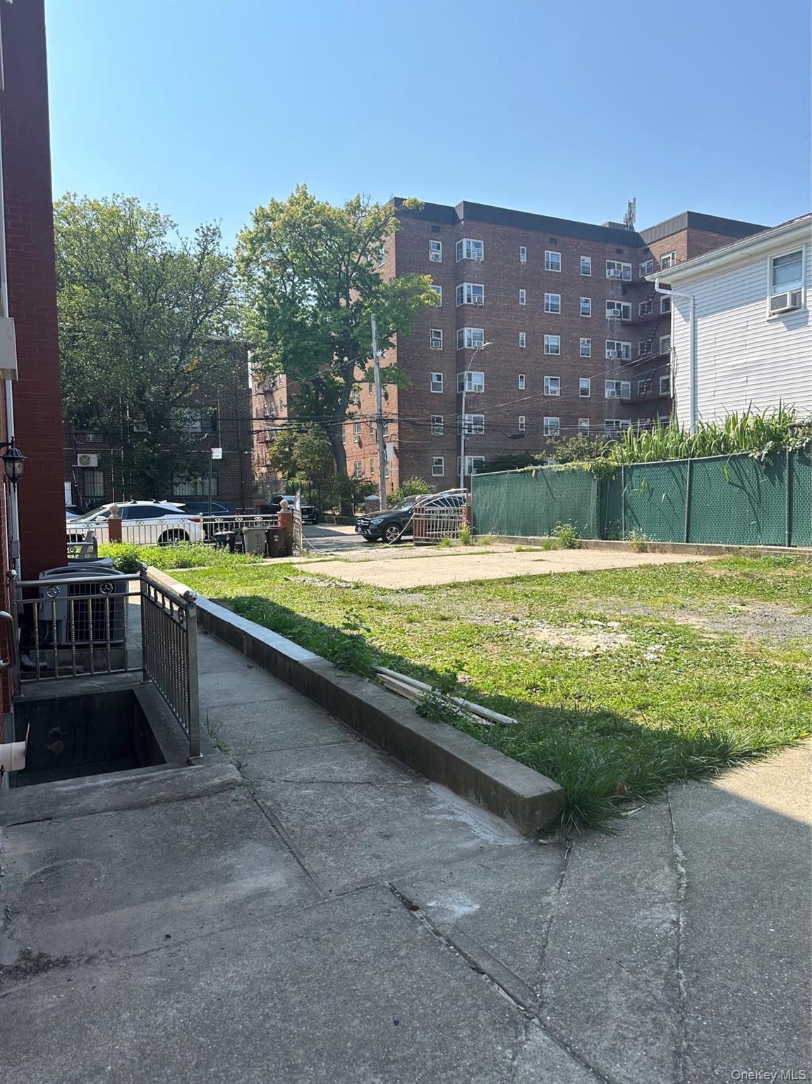 142-05 45th Avenue Queens, NY 11355 - Photo 8 of 9 View of home's community featuring fence