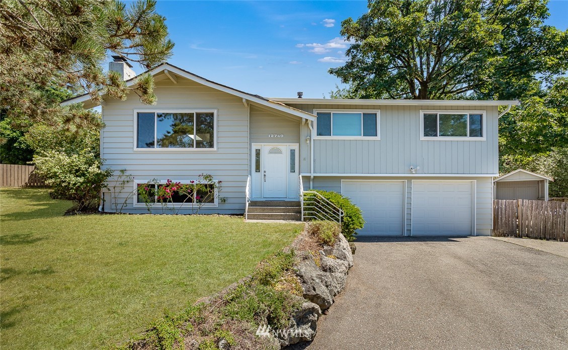 12740 Southeast 190th Place Renton, WA 98058 - Photo 1 of 28 a front view of house with yard and trees in the background