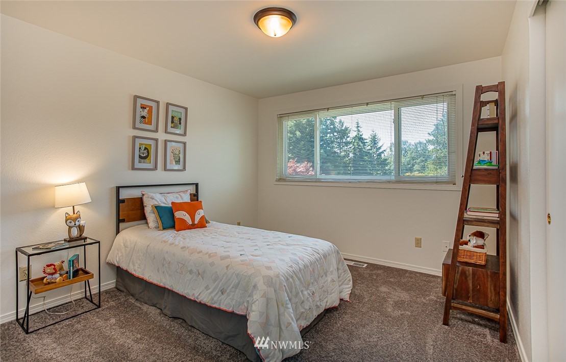 12740 Southeast 190th Place Renton, WA 98058 - Photo 13 of 28 a bedroom with a bed and a window