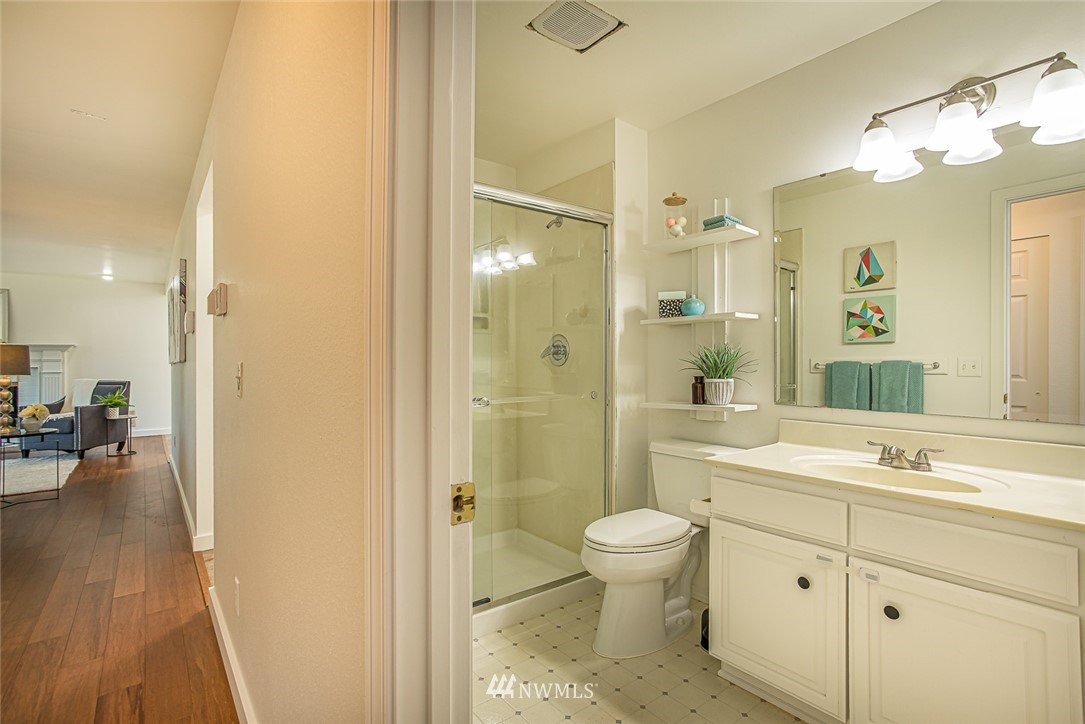 12740 Southeast 190th Place Renton, WA 98058 - Photo 14 of 28 a bathroom with a sink a toilet and shower a mirror