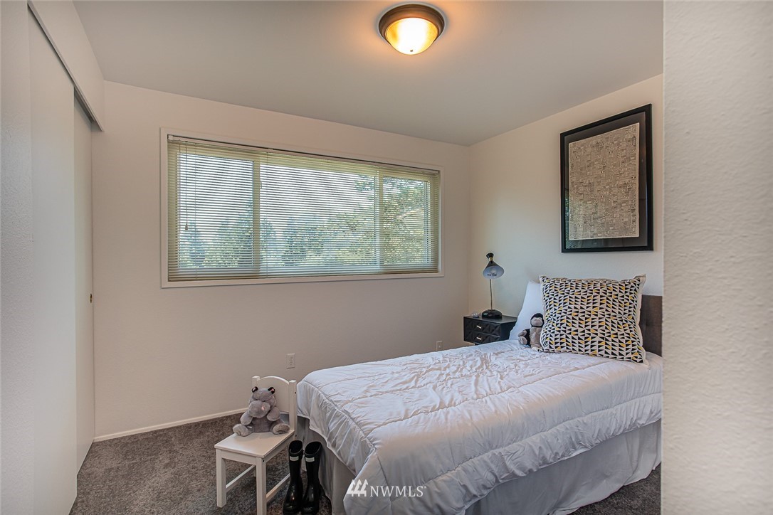 12740 Southeast 190th Place Renton, WA 98058 - Photo 15 of 28 a bedroom with a bed and a window