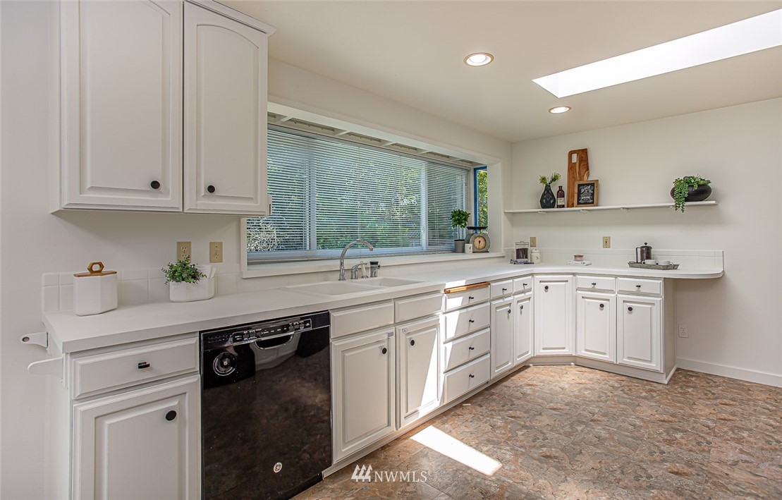 12740 Southeast 190th Place Renton, WA 98058 - Photo 7 of 28 a kitchen with white cabinets and sink