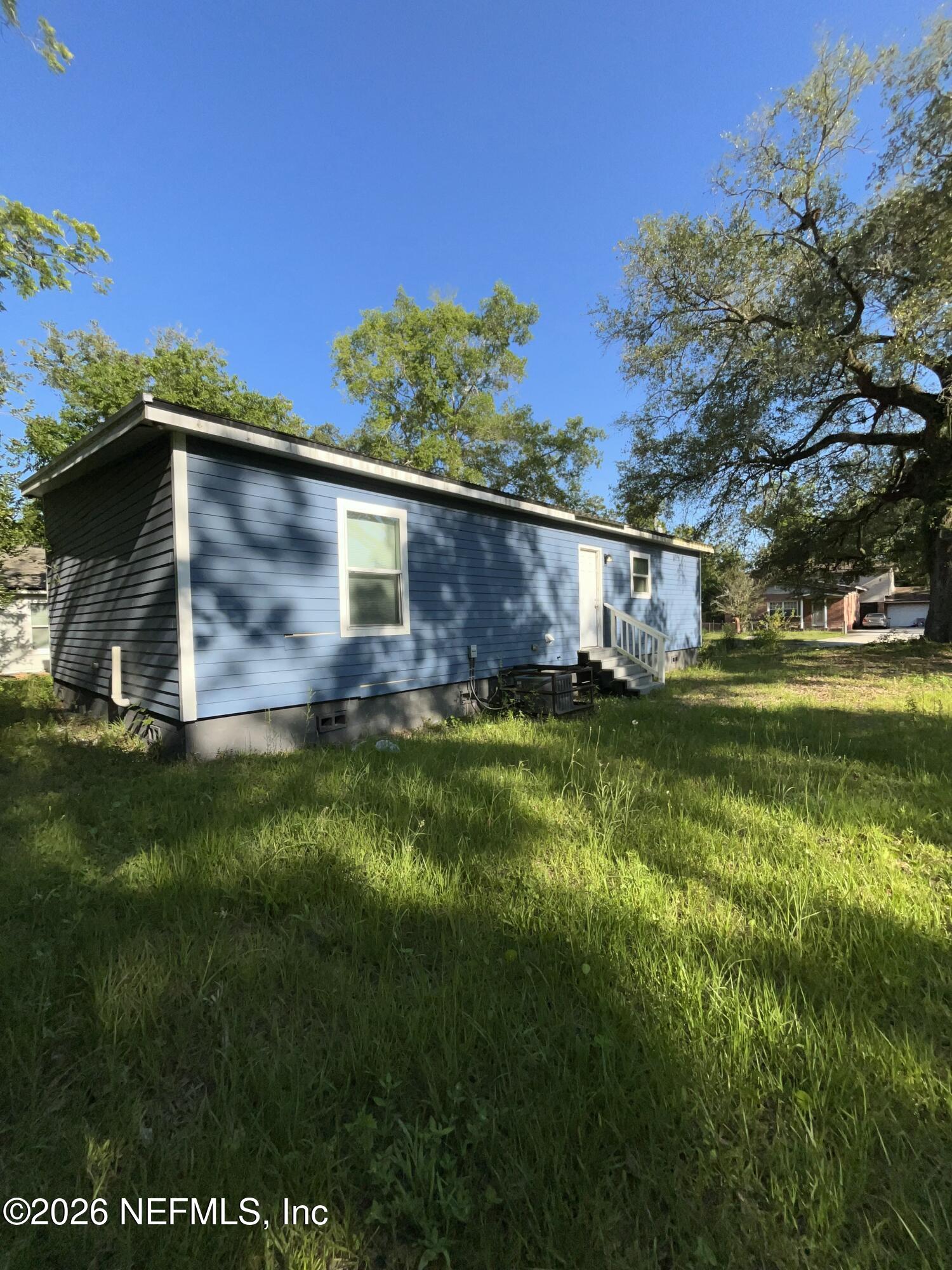 2017 Talladega Road Jacksonville, FL 32209 - Photo 3 of 34 a view of a wooden house with a yard