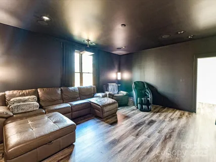 a spacious bedroom with a bed window and couch