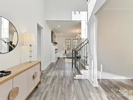 a view of a hallway with wooden floor and staircase