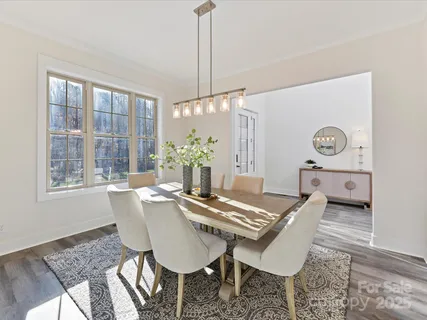 a living room with a table chairs and a table