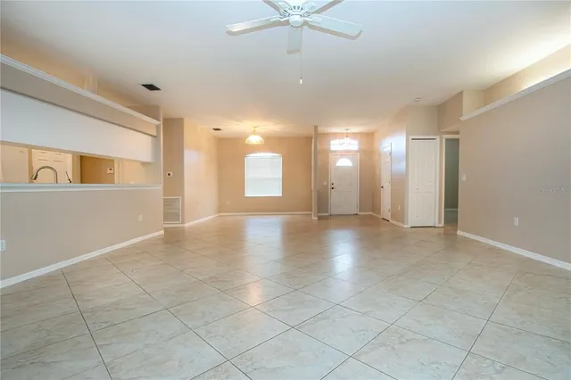 a view of a livingroom with a ceiling fan and window