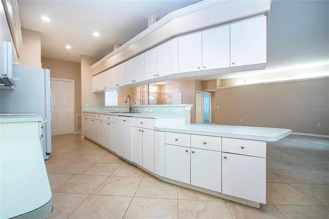 a kitchen with white cabinets